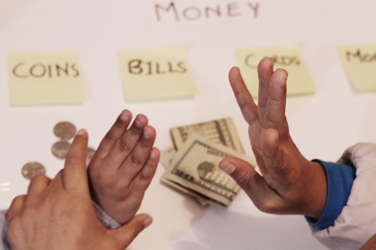 money-lesson-concept-with-baby-and-adult-hands-2026-03-17-17-49-49-utc
